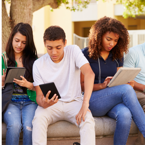 Image shows a group of university students reading books